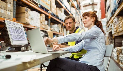 People with a computer in warehouse